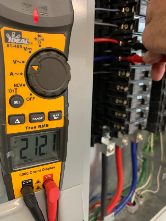 Multimeter reading 212 volts while testing an electrical panel